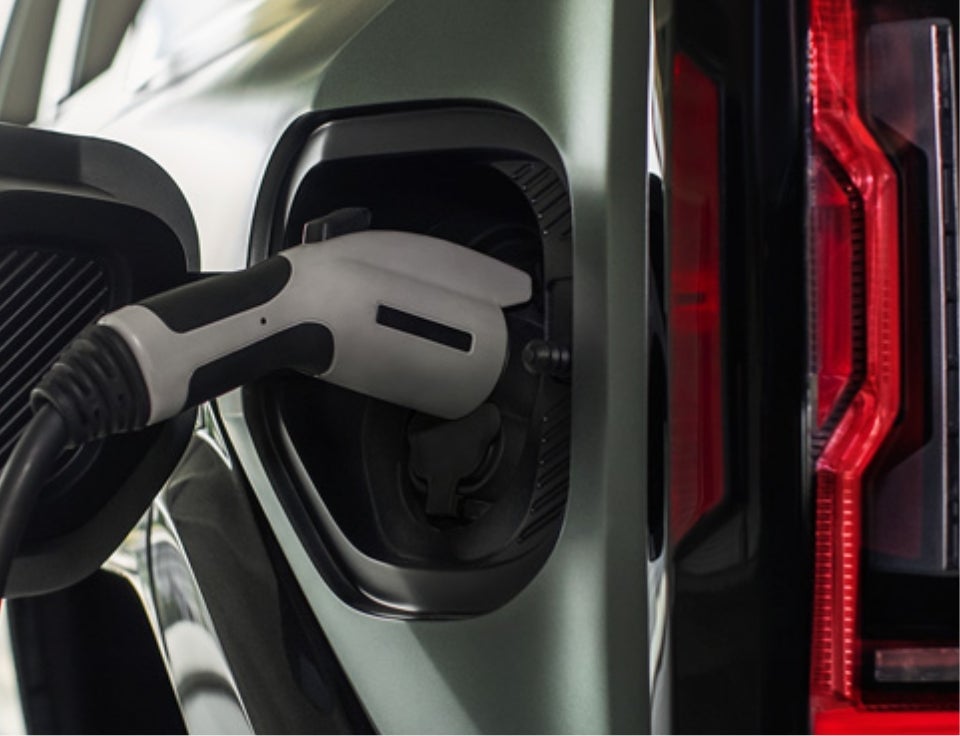 Close up of charging port with charger plugged in on a GMC Hummer EV SUV - Mark Porter GMC Ashland in Ashland KY