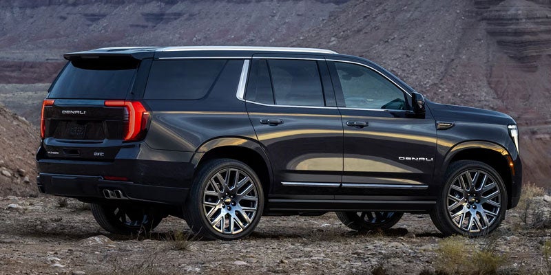 Rear three-quarter view of the 2026 GMC Yukon parked outdoors